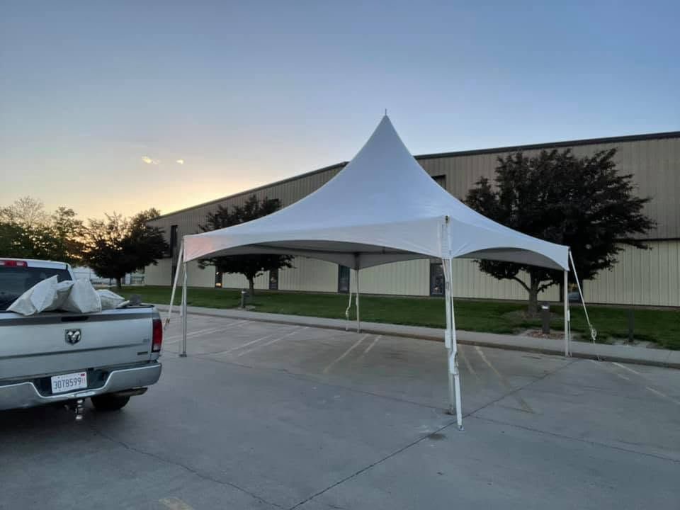 Single white high-peak tent at dusk